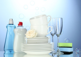 empty clean plates, glasses and cups with dishwashing liquid