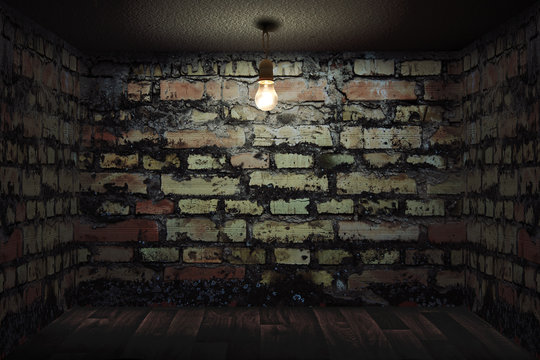Habitaci&oacute;n oscura con paredes de ladrillo