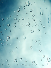 Water drops with sky and clouds background