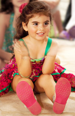 Little cheerful baby girl clap one's hands