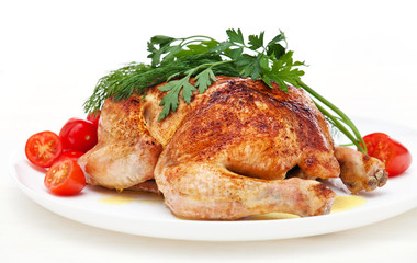 Whole roasted chicken with tomatoes and herbs on white backgroun