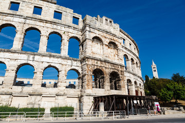 Obraz premium White Church and the Ancient Roman Amphitheater in Pula, Istria,