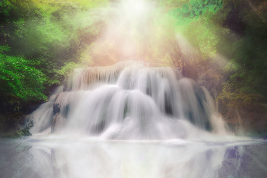 Light and waterfall in deep forest fantasy dream color