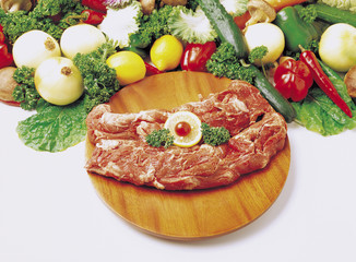 Fototapeta na wymiar slices of meat with broccoli and sliced lemons on the plate