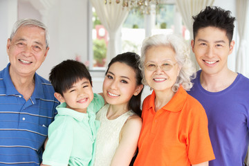 Portrait Of Multi-Generation Chinese Family Relaxing At Home