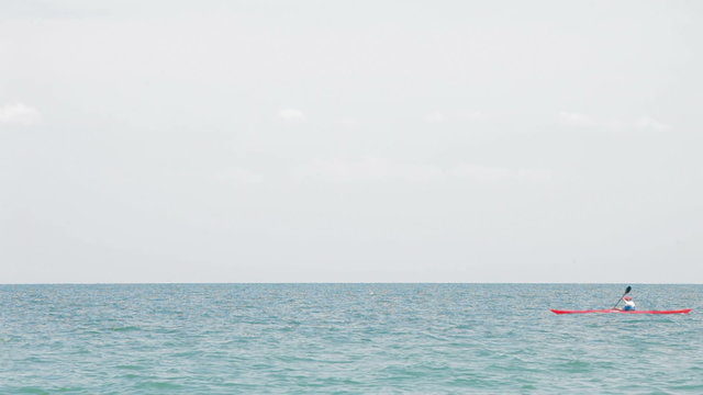 A lonely cayak boat sailing in the sea