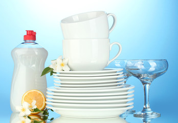 empty clean plates, glasses and cups with dishwashing liquid