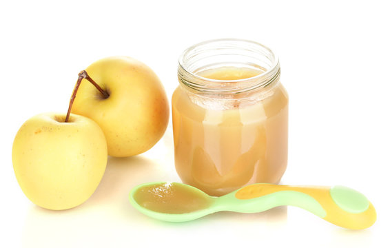 Jar Of Baby Puree With Apple And Spoon Isolated On White