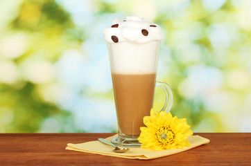 glass of fresh coffee cocktail on bright green background