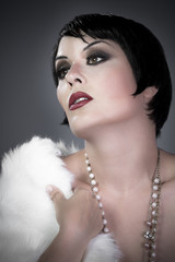gourgeos brunette flapper wearing pearls and fur