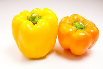 Green, red and yellow pepper isolated on white