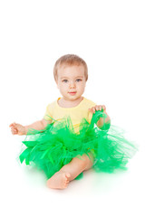 Cheerful little girl in a green skirt