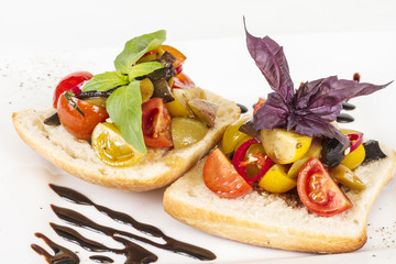 juicy tomatoes on fresh bread, pesto as topping