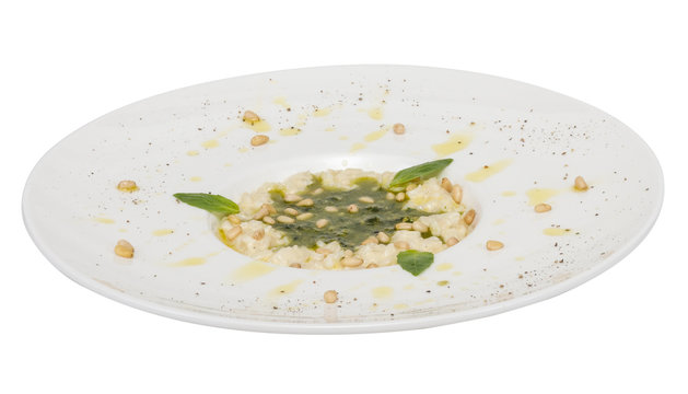 photo of delicious risotto dish with herbs and cedar nut on whit