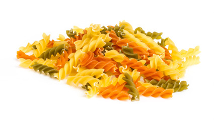 Uncooked pasta fusilli in different colours, white background