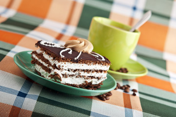 tasty cake and cup of cappuccino