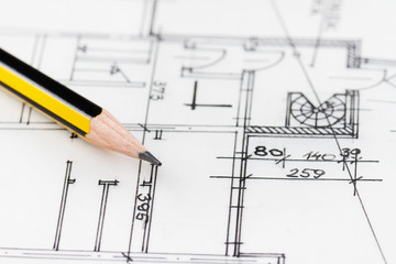 Close up of yellow pencil over architectural drawing