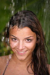 woman in tropical shower palms around