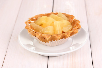 sweet cake with fruits on wooden background