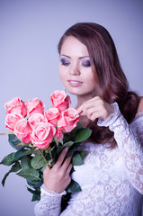 woman in bridal dress with bouquet from roses