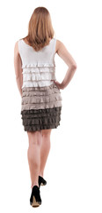 back view of going  woman  in  dress.