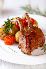 Roast rack of veal with baked vegetables and rosemary