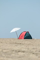 lonely parasol and sun tent on the beach