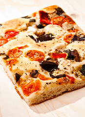 focaccia with tomatoes, olives, artichokes and vegetables