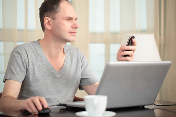 Man with laptop and mobile phone