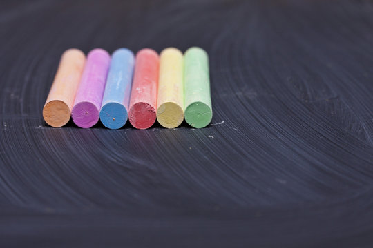 Colored chalks on a blackboard