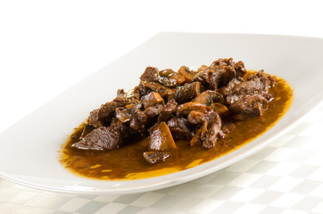 veal with mushroom sauce in a white plate