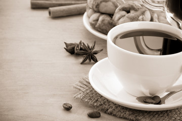 cup of coffee with beans and cakes on wood