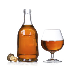 Cognac brandy bottle and glass isolated on white background