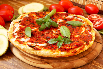 Baked pizza with tomatoes and zucchini