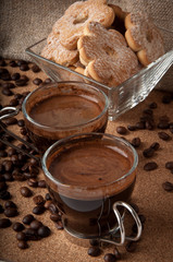 Cup of coffee and cookies in glass bowl 