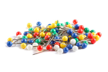 Colorful push pins on white background close up
