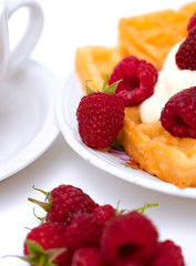 waffles with whipped cream and raspberrries