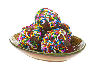 Sprinkle covered donut holes on dish
