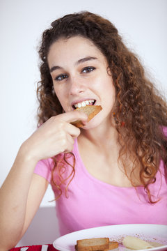 .Young Woman Eating Toast