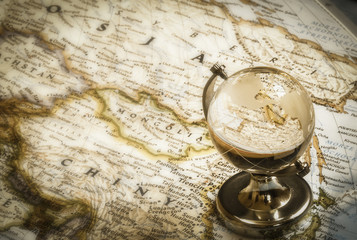 old globe glass and vintage map as  travel concept
