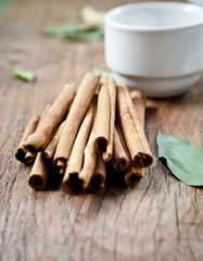 cinnamon sticks on the table with coffee cup.