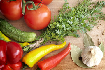 Vegetables herbs and spices on kitchen cutting board