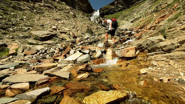 hiker crossing stream