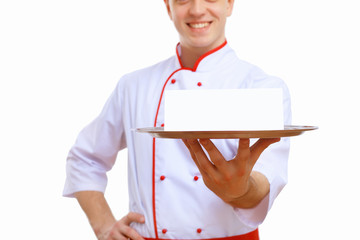 Cook holding an empty tray