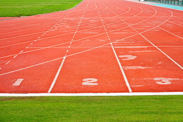 red running lane with grass