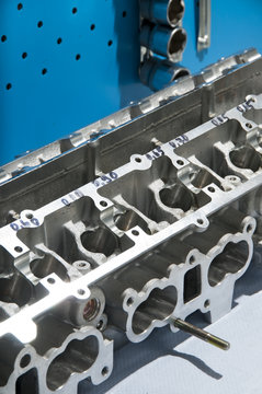 The block of cylinders from the engine of a sports car on a work