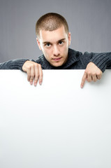 Young man pointing on white board