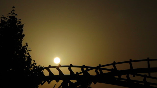 Line of dragon roller coaster rail (silhouette at sunset)
