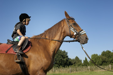 young boy ride a horse
