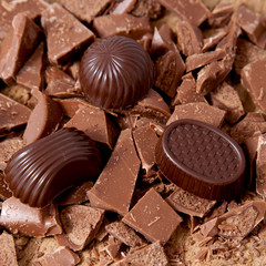 Chocolate different candies and broken pieces of milk chocolate